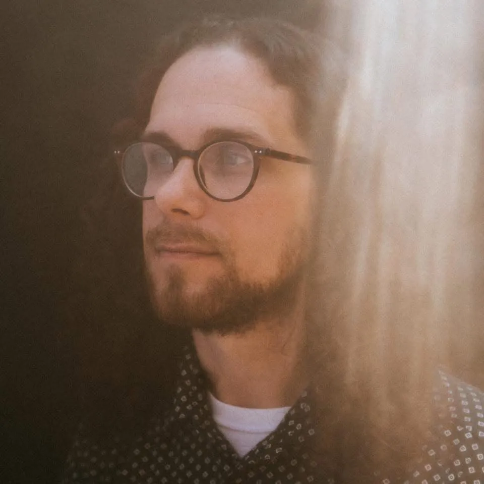 Stephen McNeill, Southaven music teacher, in round glasses looking off to the side